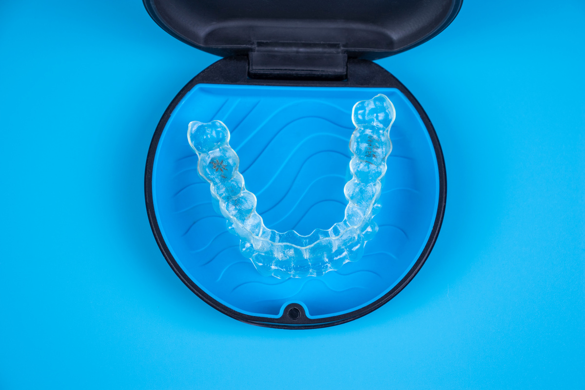 Invisalign transparent braces in a plastic case. Orthodontic invisible retainers and aligners